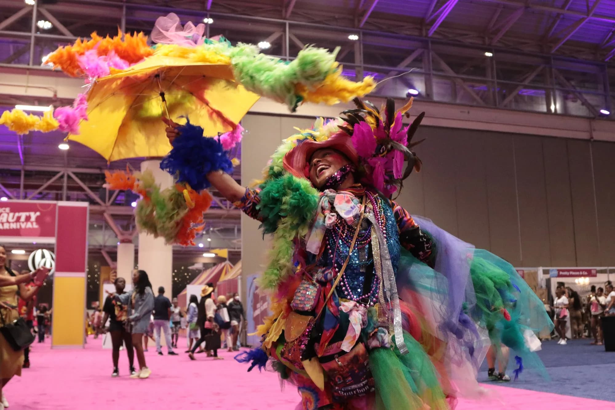 Event photo of a costumed performer in feathers at an expo