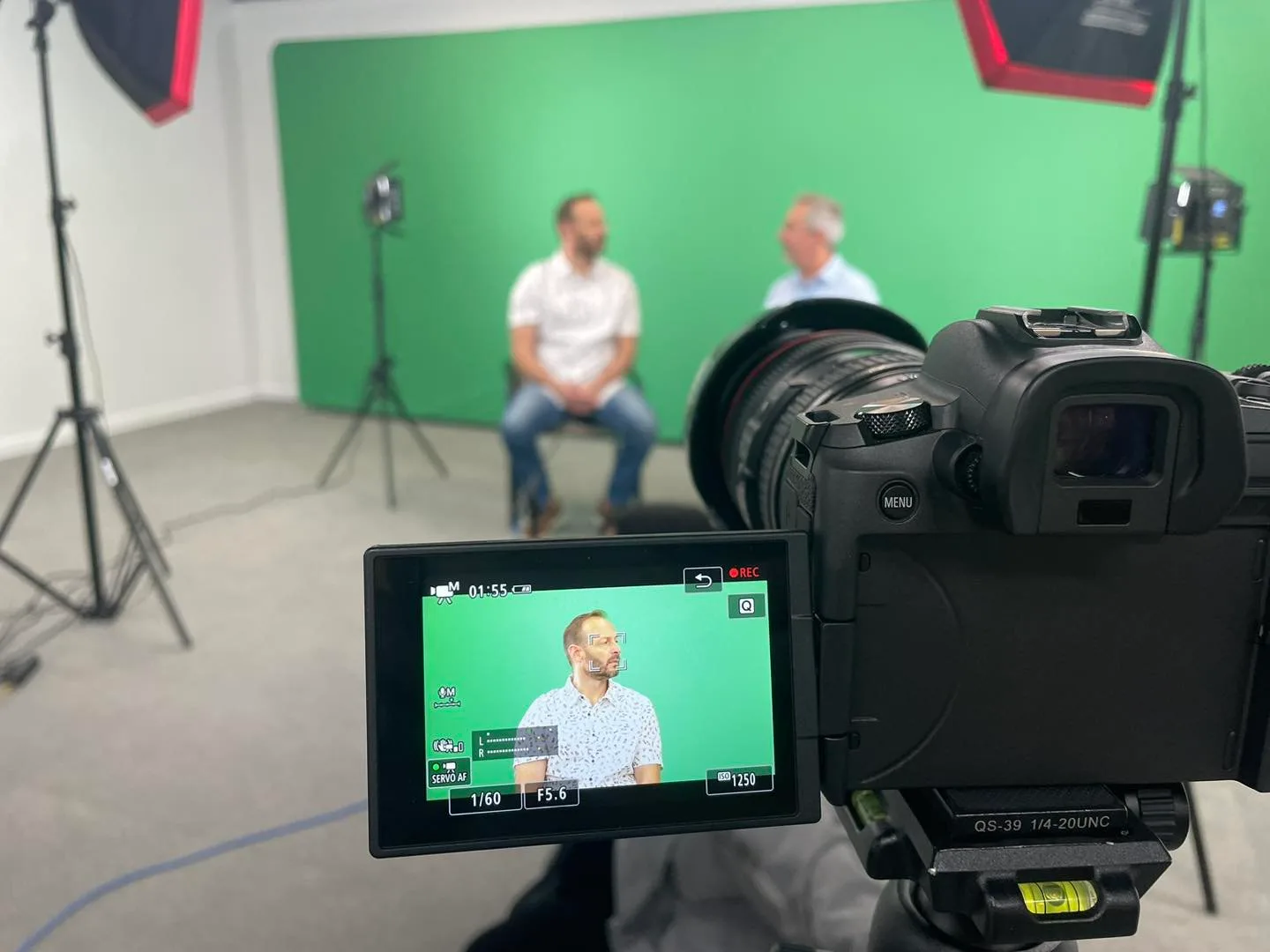 Camera monitor framing an interview on a green screen set