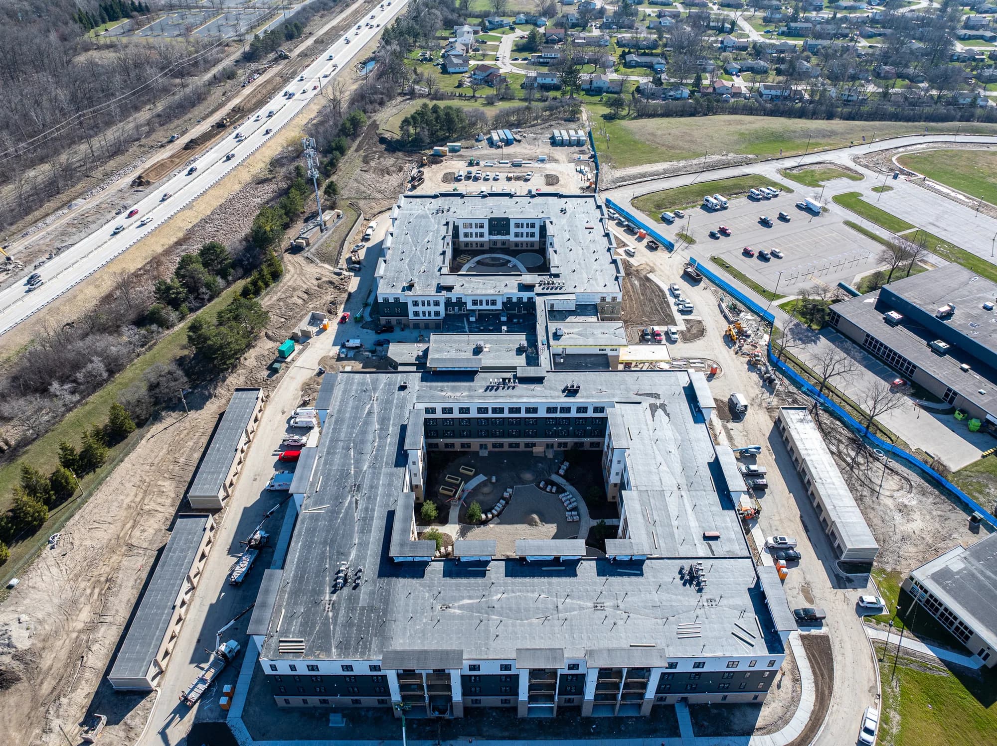 Aerial view of a multi-building apartment complex with new roofs