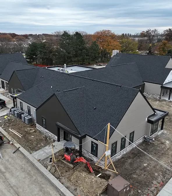 Aerial view of new condominium buildings with shingle roofs