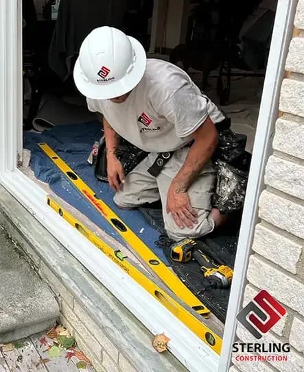 Installer leveling the sill of a new door opening