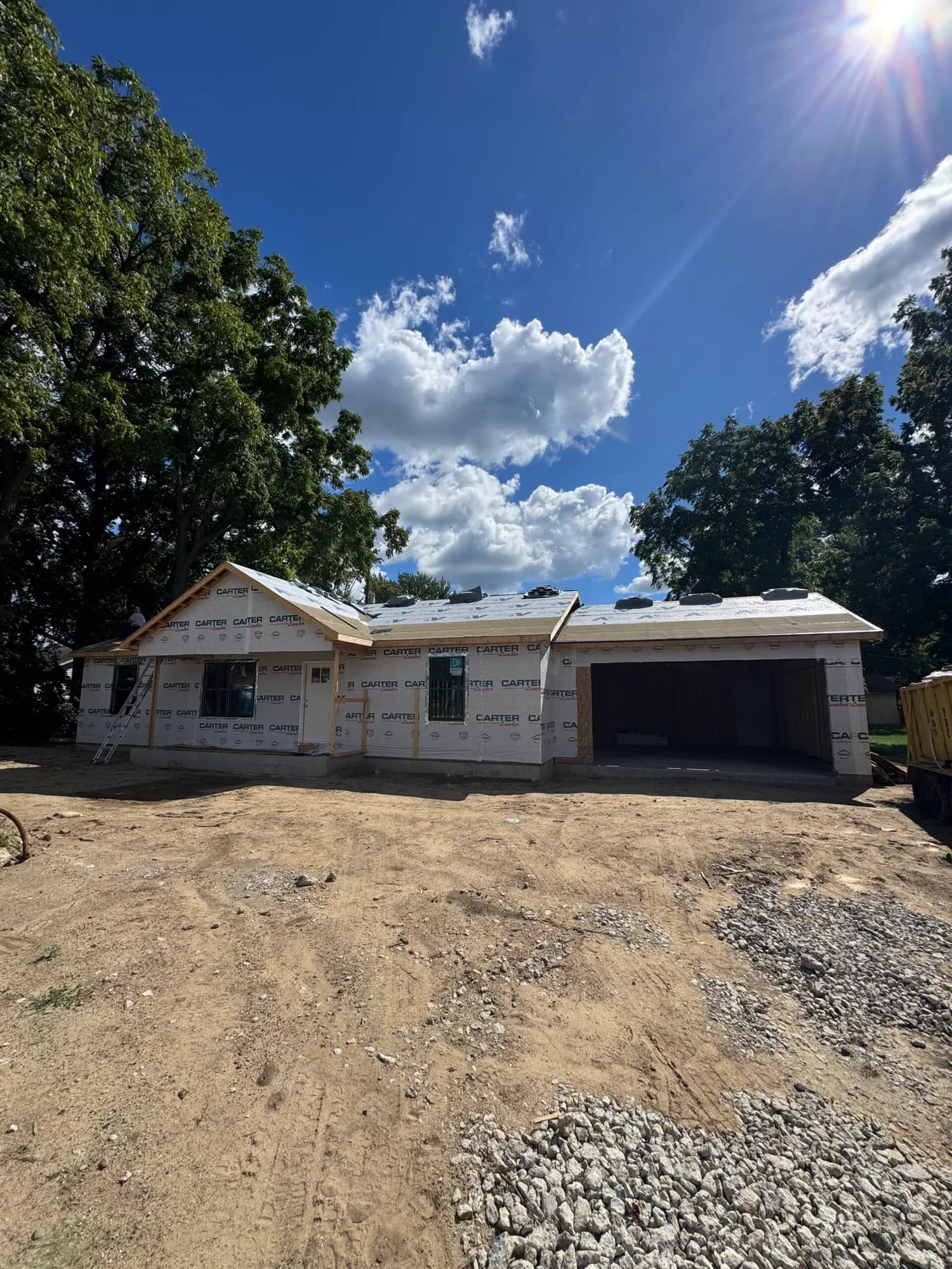 New single-story home framed and sheathed on a cleared lot