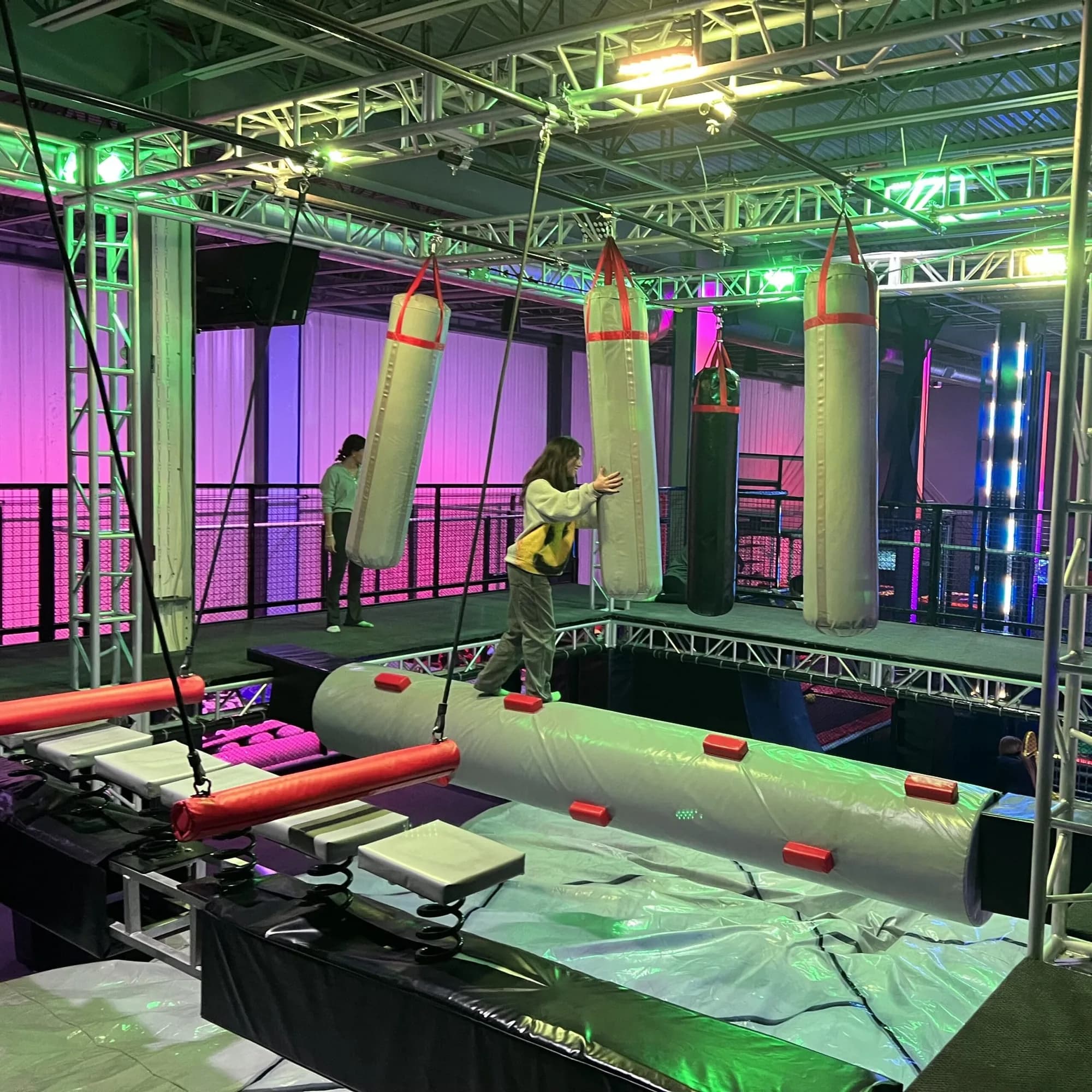 Adventure park obstacle course with hanging bags and balance beams