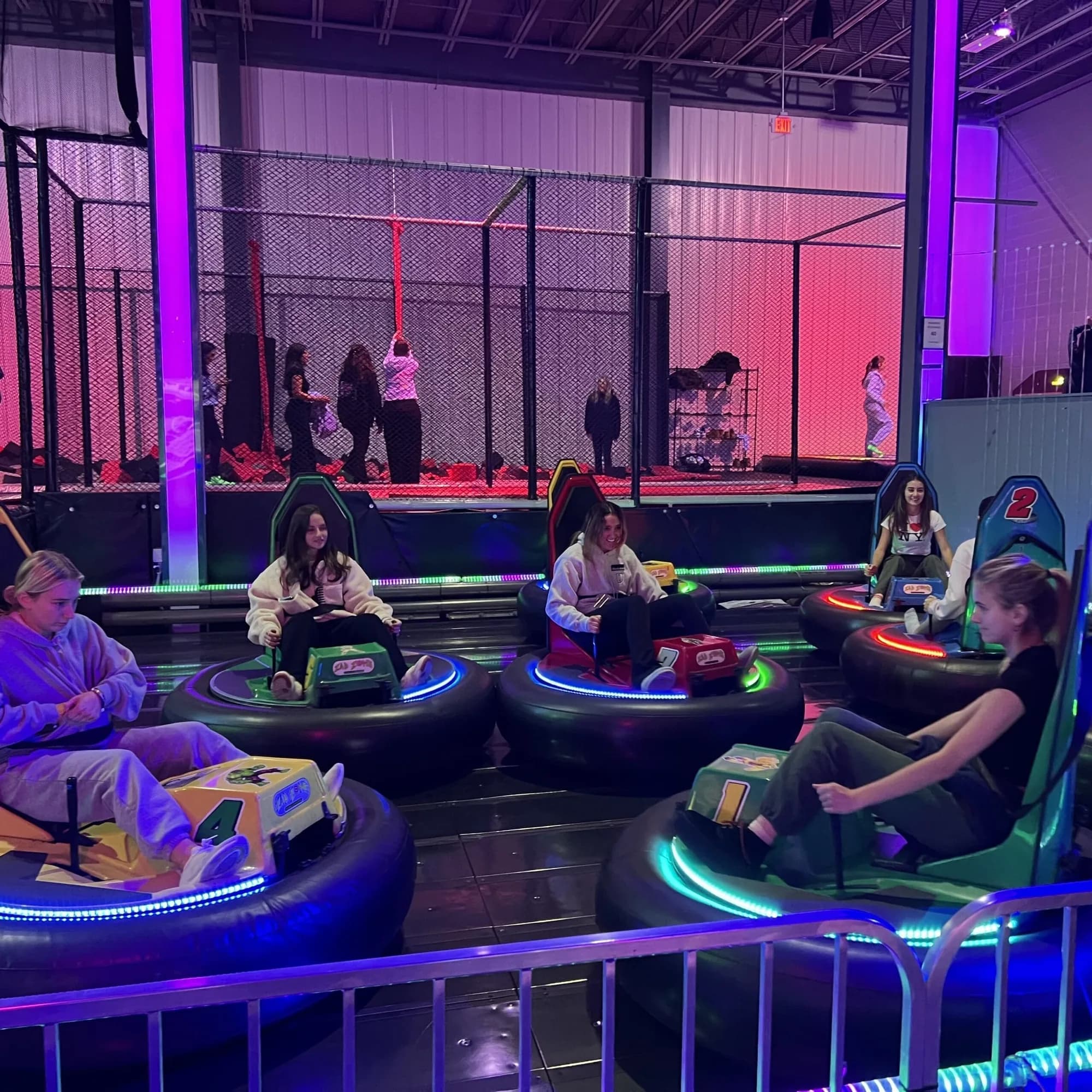 Guests riding inner-tube bumper cars in the attractions hall