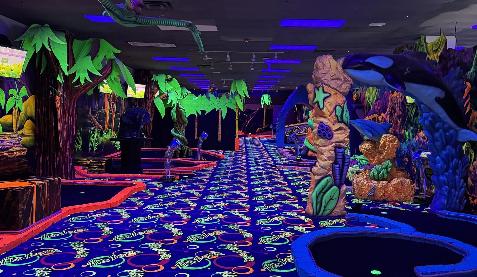 Black-light glo-golf course with jungle and underwater scenery