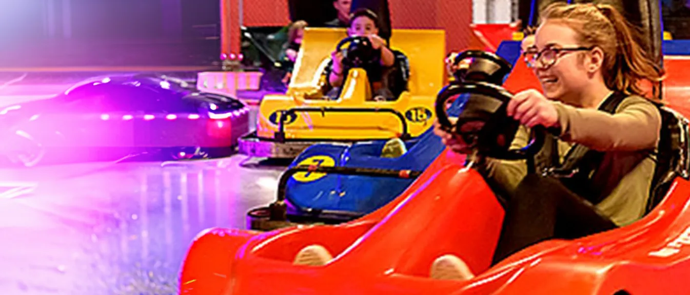 Drivers in go-karts on the indoor track