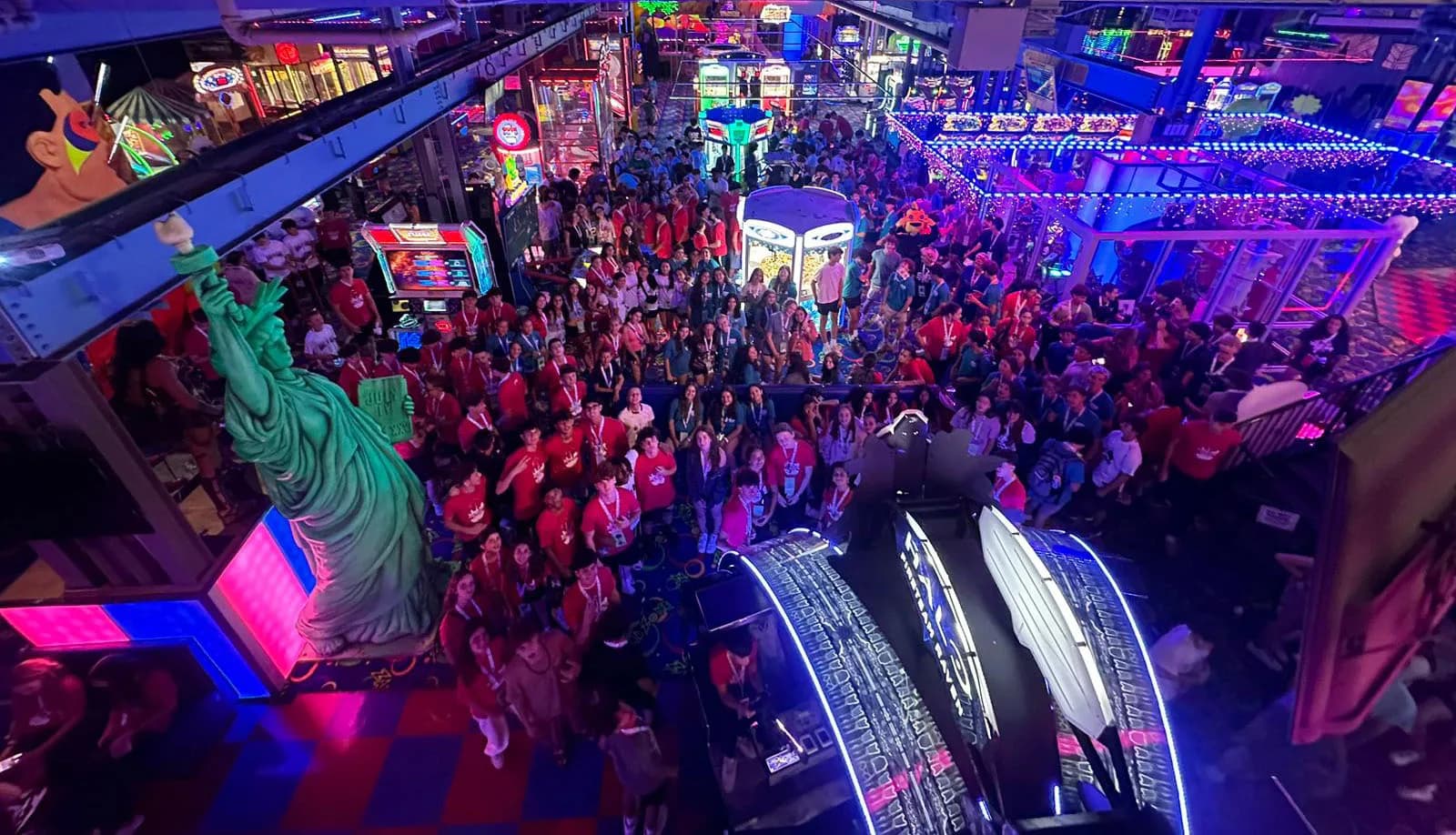 Large group of young visitors gathered in the arcade