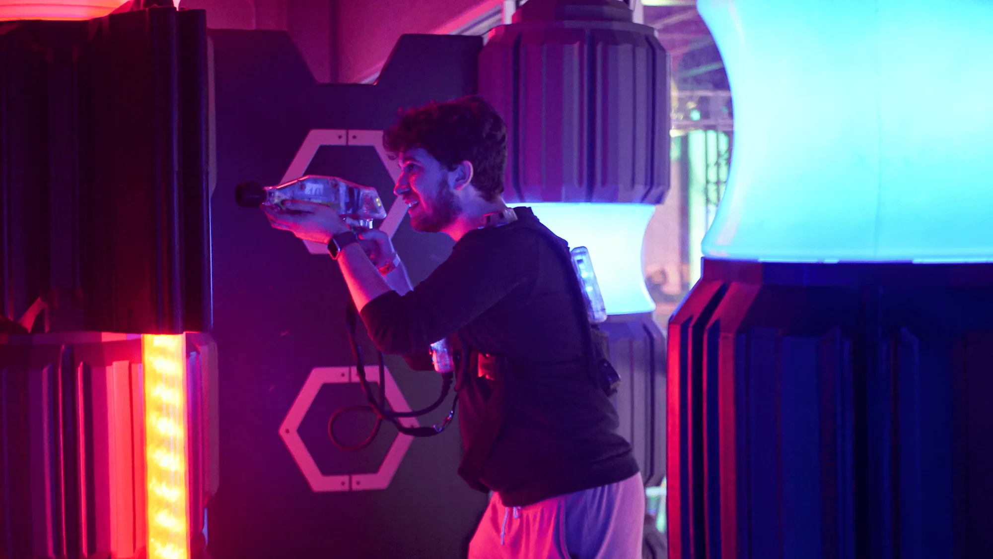 Player aiming a phaser in the laser tag arena