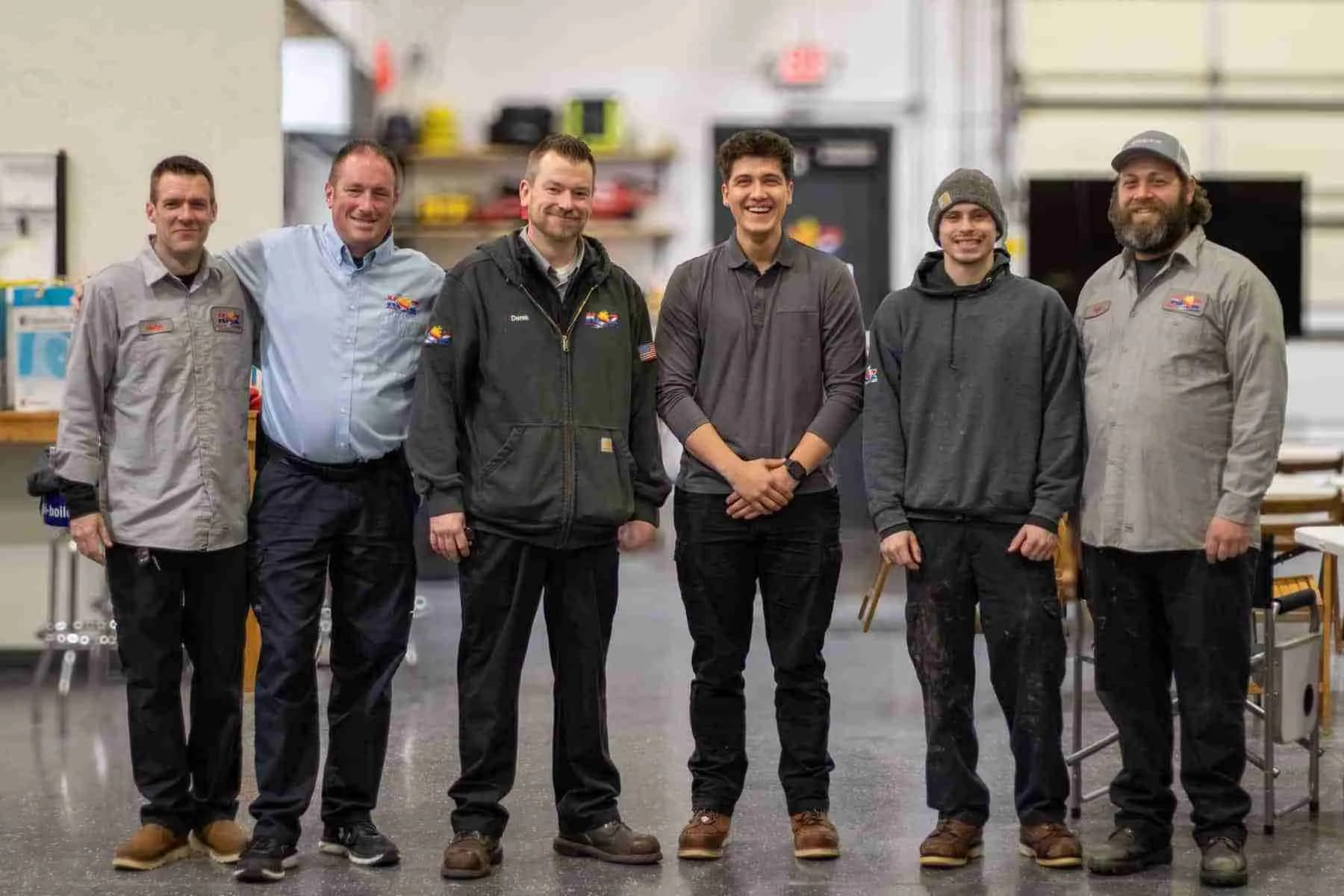 Koz Heating & Cooling team standing together in the shop