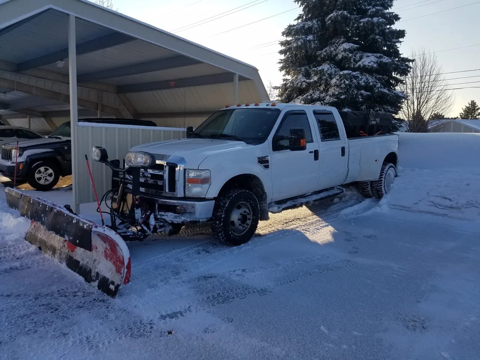 Pickup truck fitted with a snow plow after a snowfall