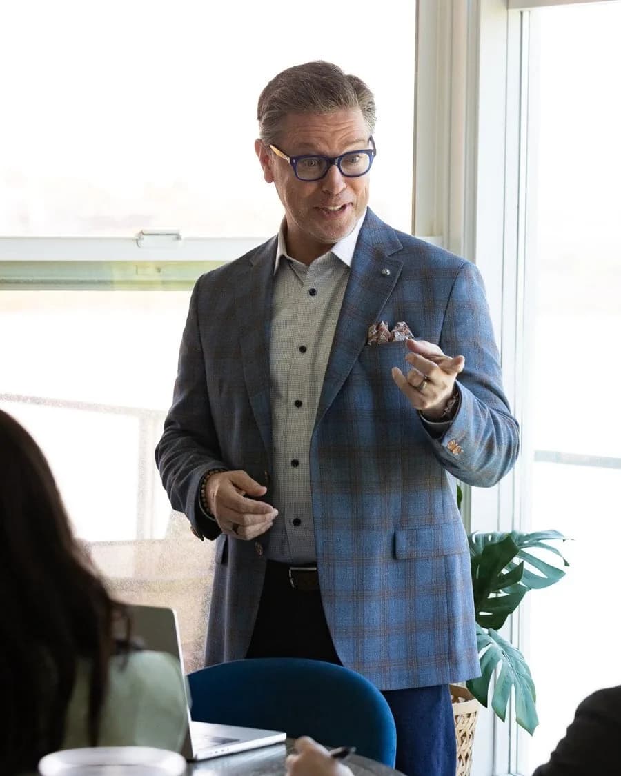 Bill Green standing and leading a session in a bright meeting room