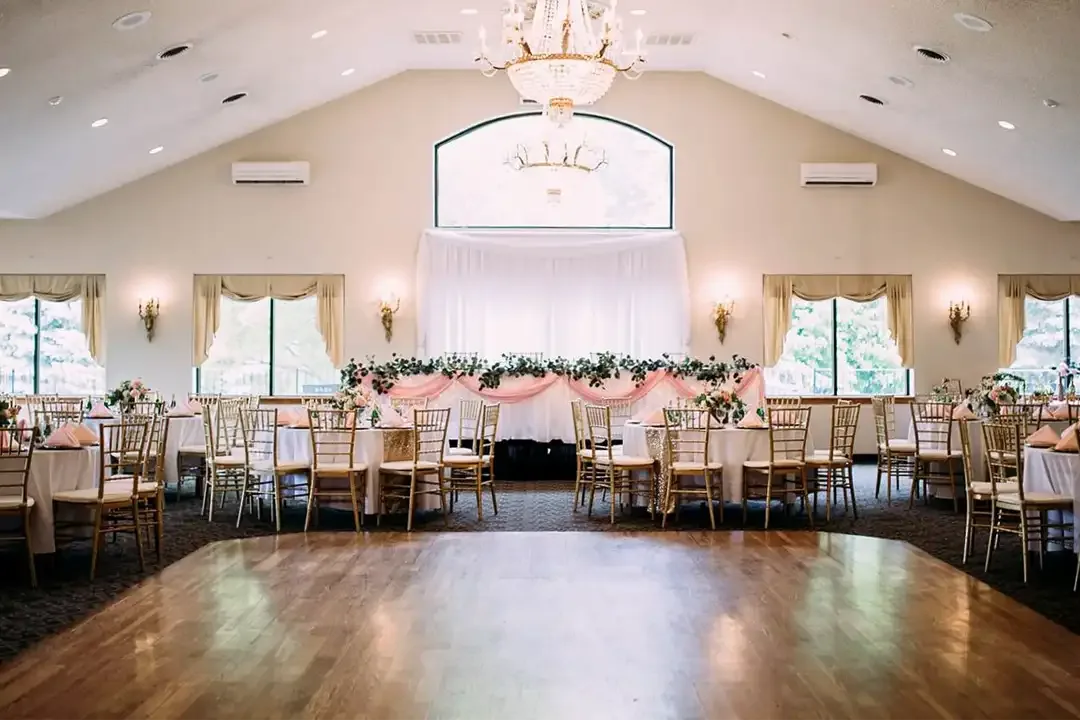 Reception hall with chandelier, dance floor and head table