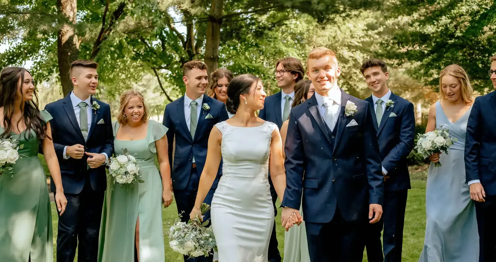 Wedding party walking together across the grounds