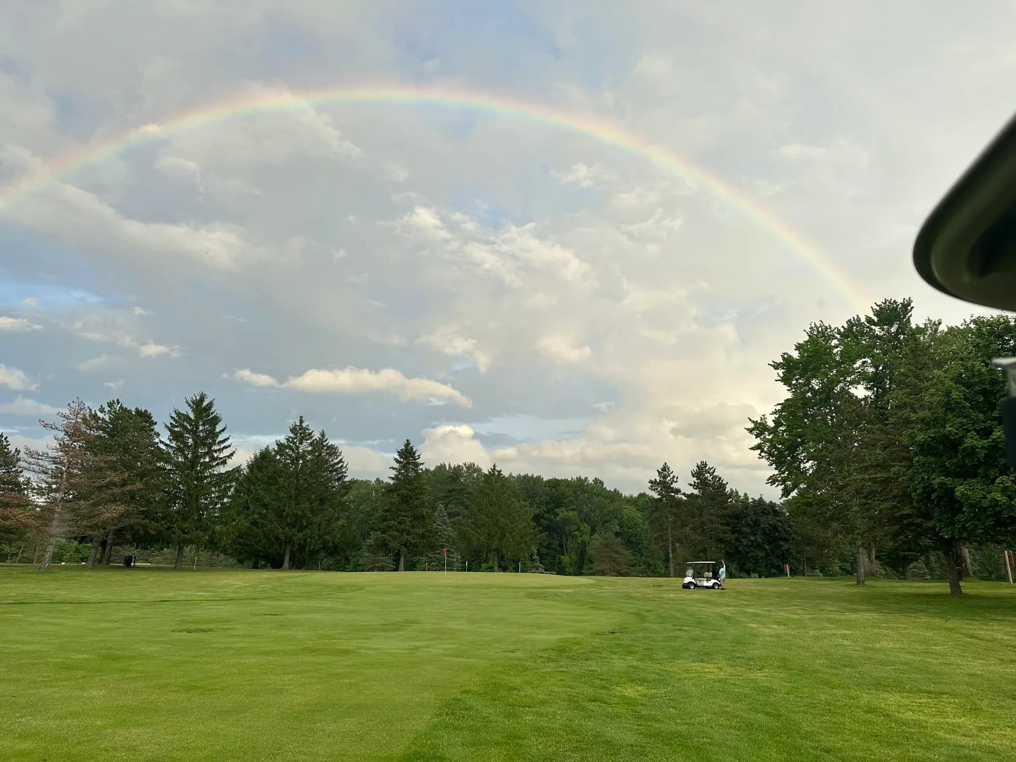 Open fairway under a rainbow