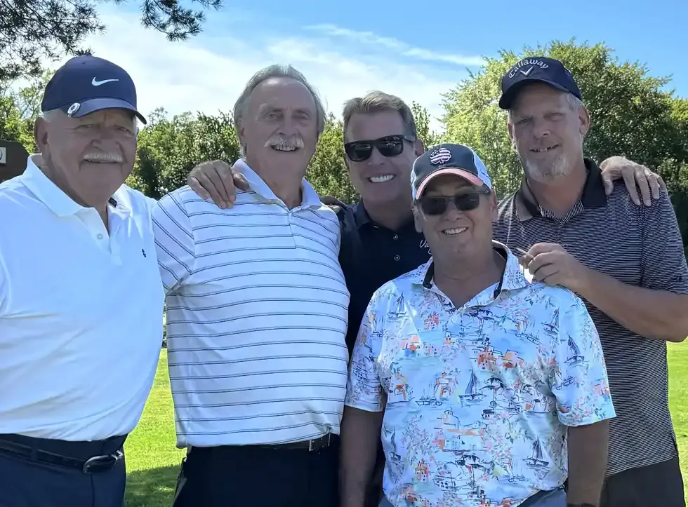 Group of golfers posing together on the course
