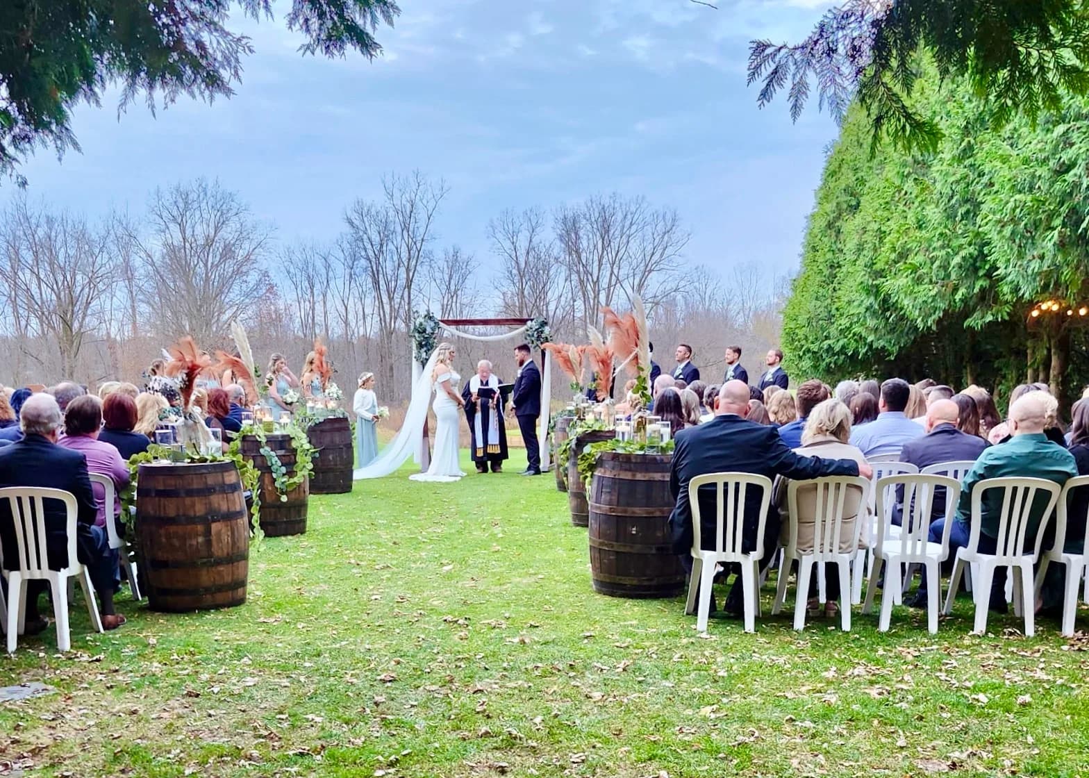 Outdoor wedding ceremony on the lawn with guests seated