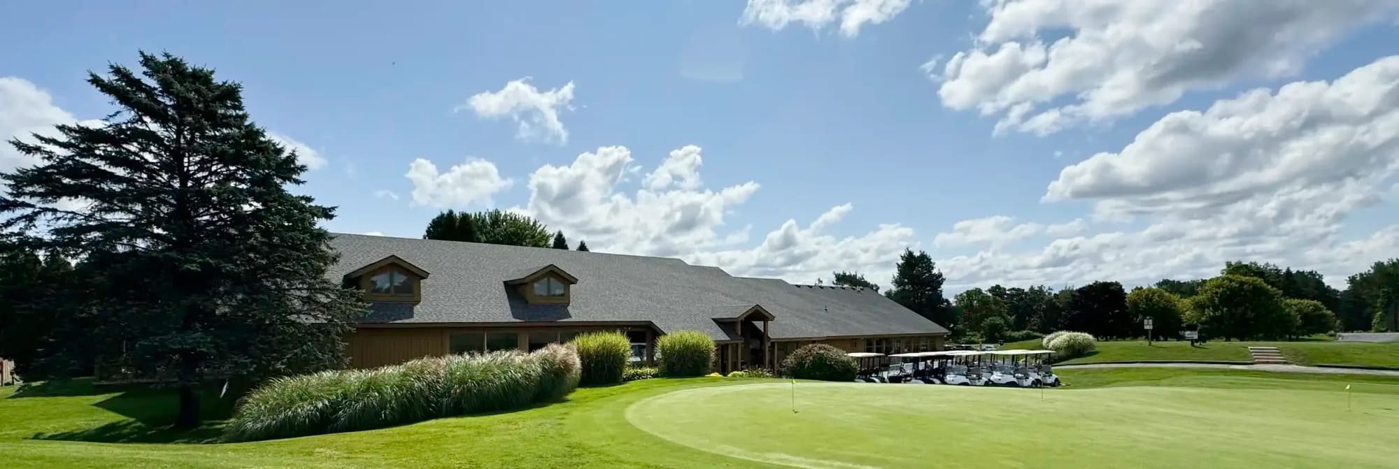 Clubhouse and golf carts beside the course