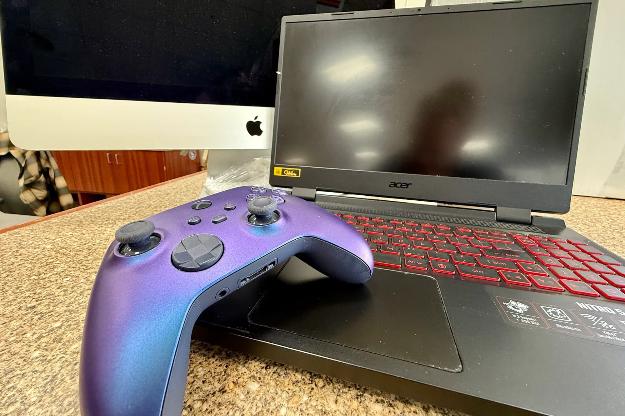 Gaming laptop and game controller on a store counter