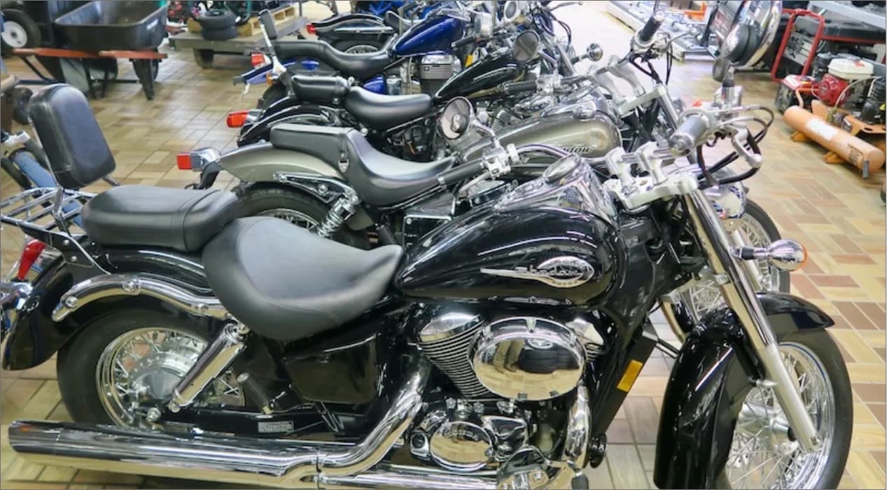 Row of motorcycles lined up on the showroom floor