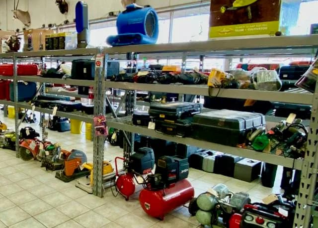 Shelves of power tools, tool cases and air compressors